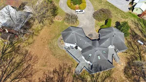 an aerial view of a house with swimming pool and outdoor space