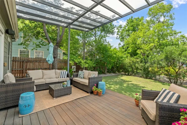 a outdoor living space with patio furniture and wooden floor