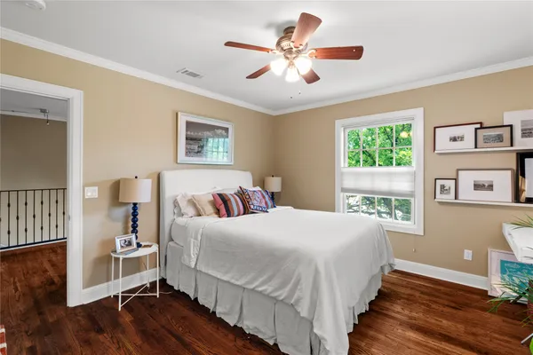 a bedroom with a large bed and a window