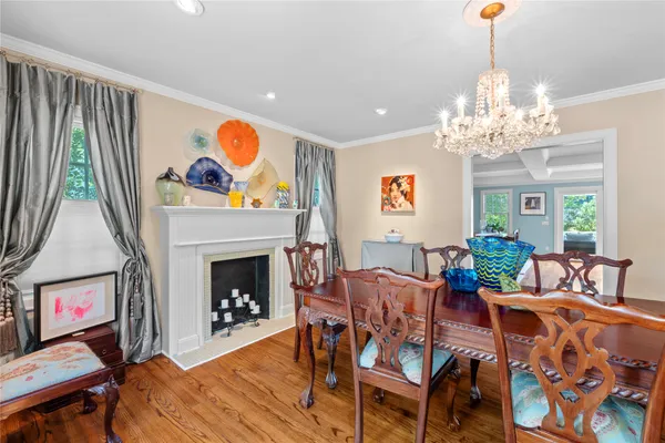 a living room with furniture a chandelier and a fireplace