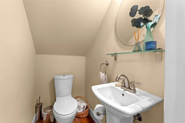 a bathroom with a sink a toilet and mirror