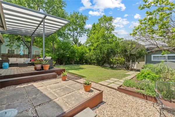 a view of a backyard with plants and a patio