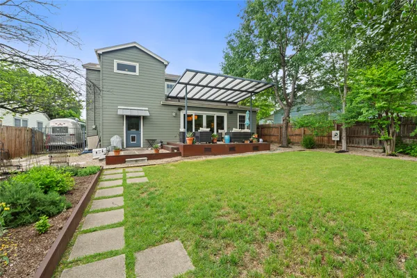 a view of a house with a yard patio and swimming pool