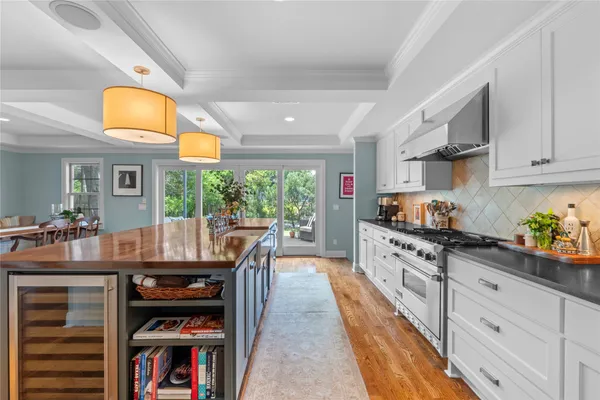 a kitchen with stainless steel appliances granite countertop a stove and cabinets