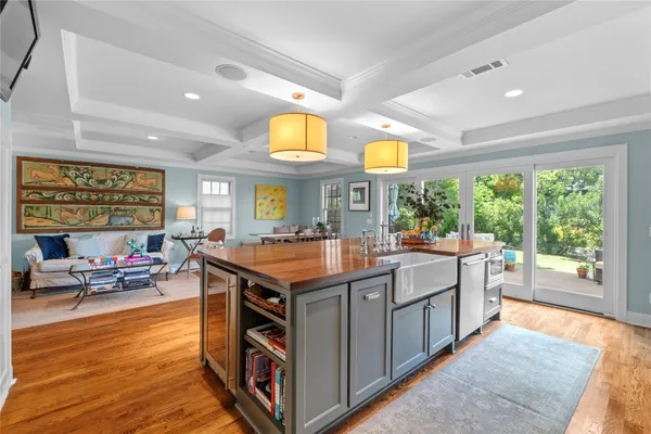 a kitchen with stainless steel appliances granite countertop a stove and a large window