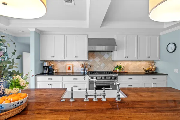 a kitchen with stainless steel appliances granite countertop a stove and cabinets