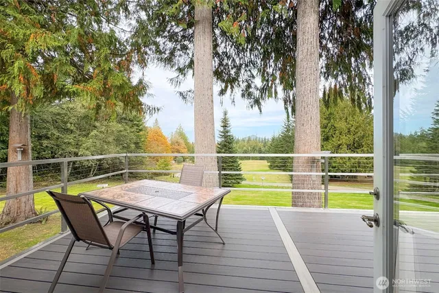 a view of a chairs and table on the wooden deck