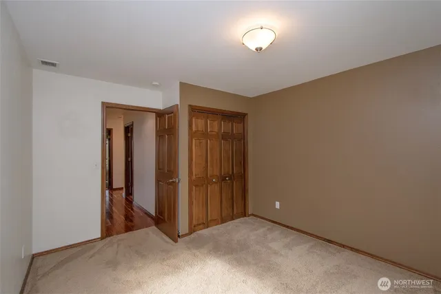 a view of an empty room and closet area