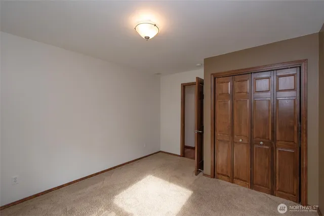 an empty room with closet area