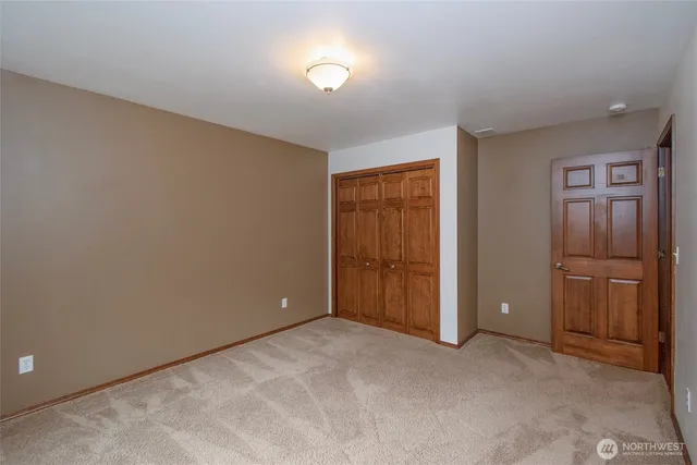 a bedroom with a couch and a dresser