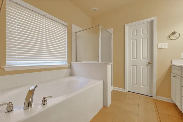 a bathroom with a bathtub and a shower
