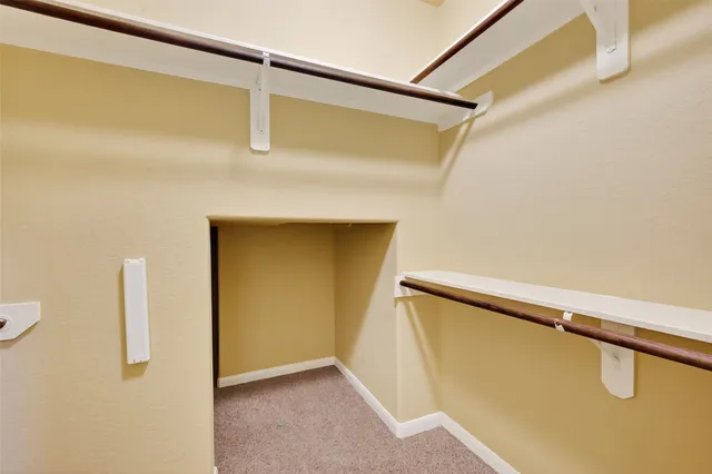 a view of a room with wooden floor staircase and a kitchen space