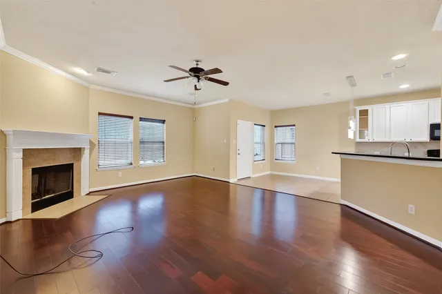 a view of an empty room with a window and fireplace