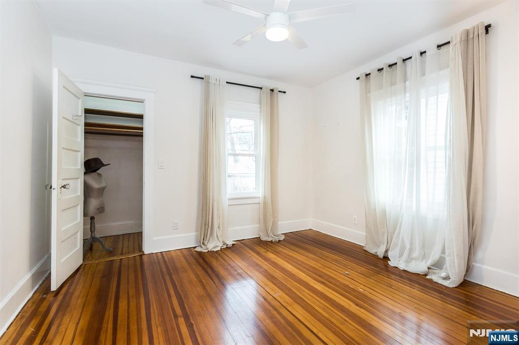 56 Walnut Crescent, Unit 1 Montclair, NJ 07042 - Photo 12 of 18 an empty room with wooden floor and a window