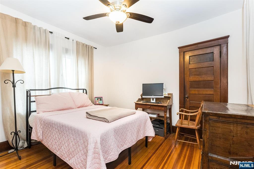 56 Walnut Crescent, Unit 1 Montclair, NJ 07042 - Photo 13 of 18 a bedroom with a bed and a chandelier