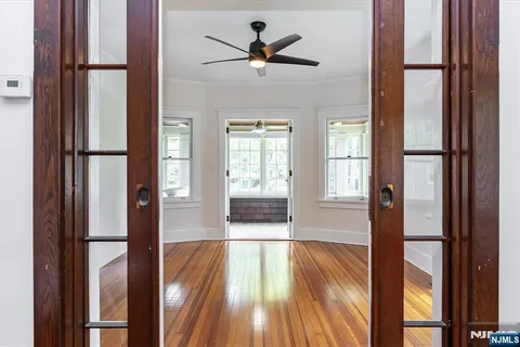 a view of empty room with a window and wooden floor