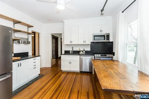 a large kitchen with cabinets a sink and a stove