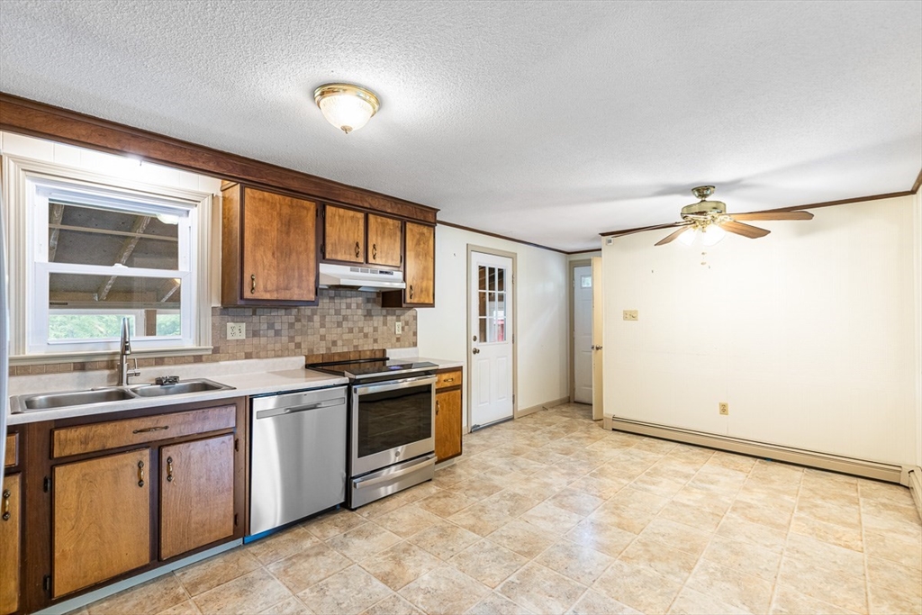 99 Swansom Road Swansea, MA 02777 - Photo 11 of 42 a kitchen with a sink stove and cabinets