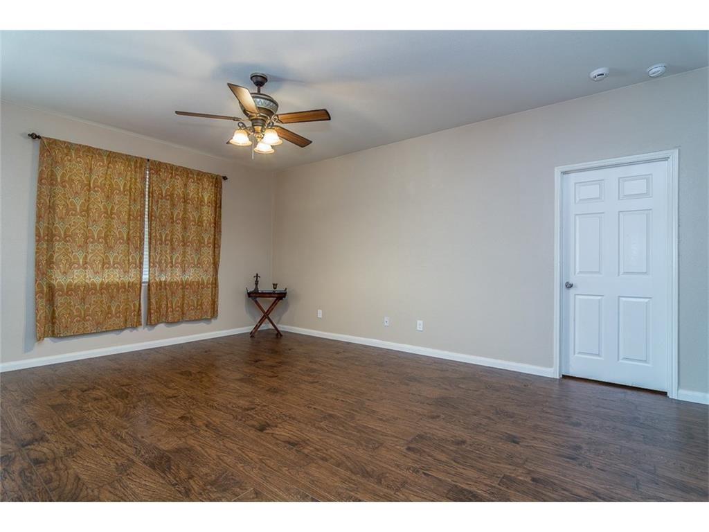 1009 Hawthorne Road Anna, TX 75409 - Photo 7 of 22 Spacious room featuring wood-finish flooring, a ceiling fan with integrated lighting, and neutral wall tones