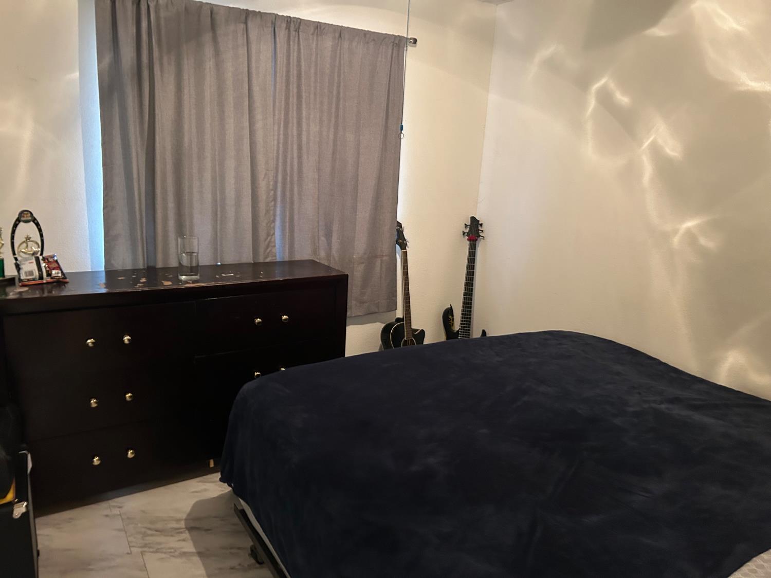 624 Park Hurst Way Modesto, CA 95358 - Photo 8 of 13 a bedroom with a bed and a chandelier