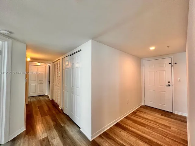 a view of hallway with wooden floor