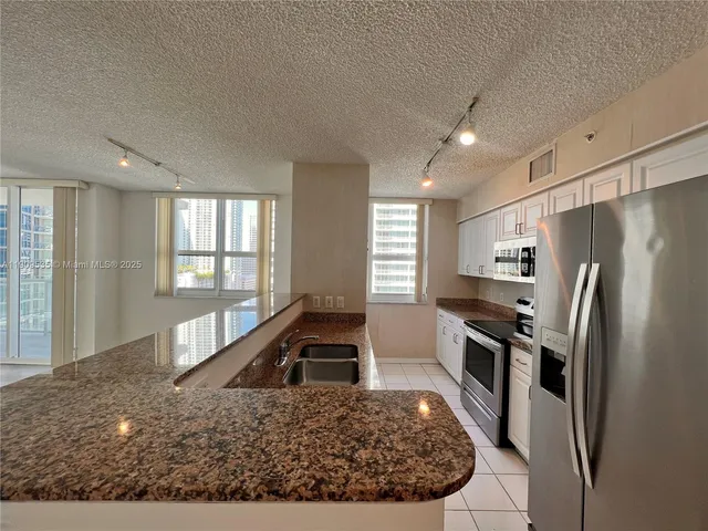 a kitchen with a refrigerator and a sink