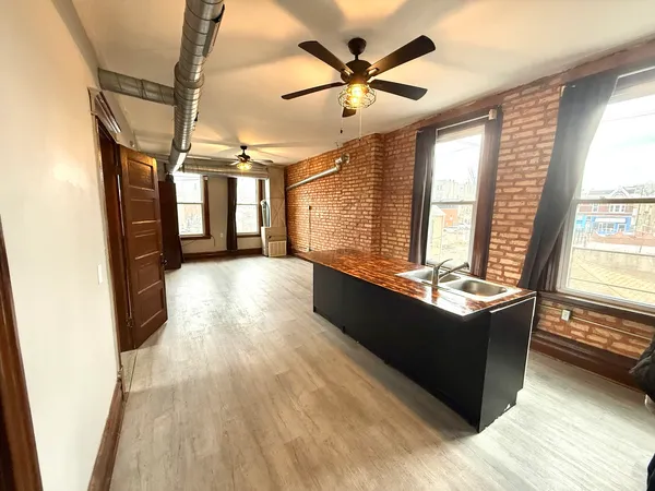 a large room with wooden floor and windows