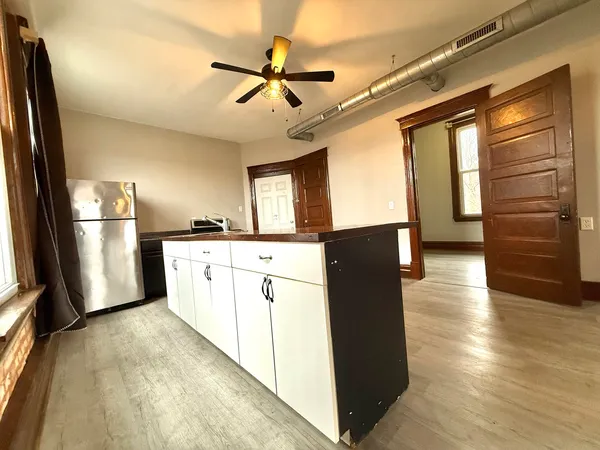 a kitchen with stainless steel appliances granite countertop a refrigerator a stove and a refrigerator