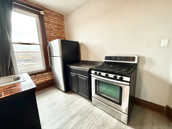 a kitchen with stainless steel appliances a stove and a microwave