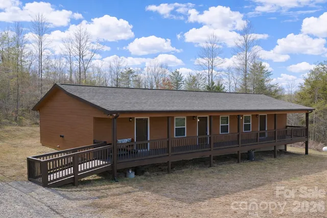 a backyard of a house with wooden fence and a bench