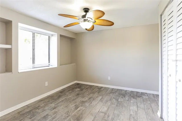a view of a room with wooden floor and window