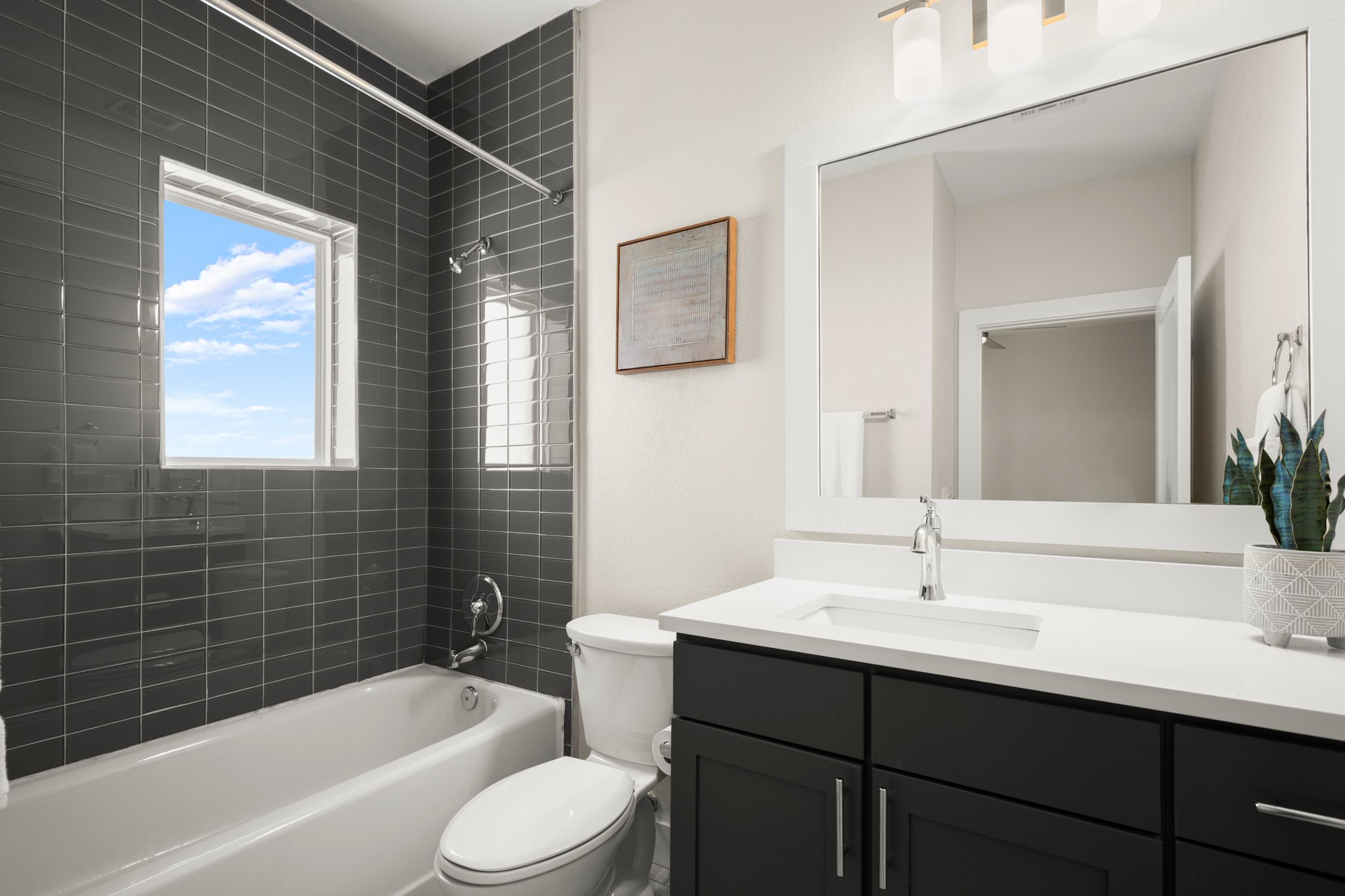 2827 Manor Road, Unit 3105 Austin, TX 78722 - Photo 21 of 26 a bathroom with a sink mirror bathtub and toilet