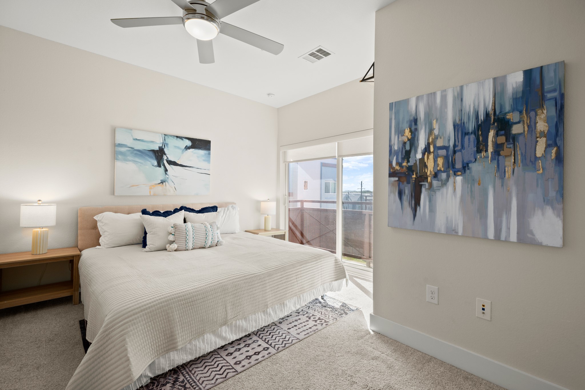 2827 Manor Road, Unit 3105 Austin, TX 78722 - Photo 6 of 26 a bedroom with a large bed and a chandelier