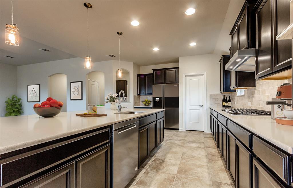 717 Carriage Hl Road Midlothian, TX 76065 - Photo 3 of 9 Large island overlooking gathering room and dining areas *Model Representation*