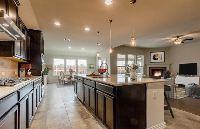 a kitchen with counter top space appliances and a ceiling fan