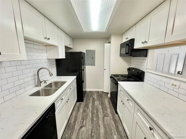 a view of a livingroom with a kitchen space and a window