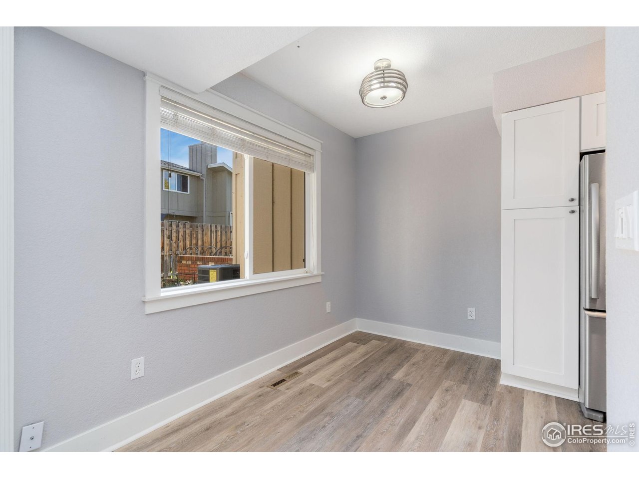 3036 Regatta Lane, Unit 2 Fort Collins, CO 80525 - Photo 8 of 22 Dining space off of kitchen and pantry cabinet left of refrigerator
