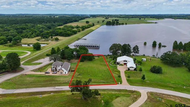 an aerial view of a house with a yard lake swimming pool and outdoor seating