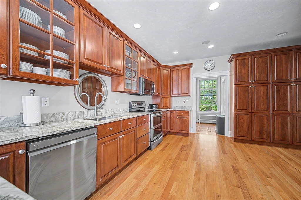 270 Mendon Road Sutton, MA 01590 - Photo 12 of 42 a kitchen with stainless steel appliances granite countertop wooden cabinets and sink