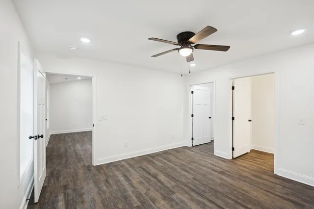 a view of an empty room and wooden floor