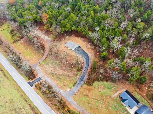 a view of a yard with wooden fence