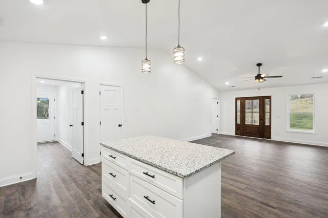 a kitchen with a stove a refrigerator and a coffee table