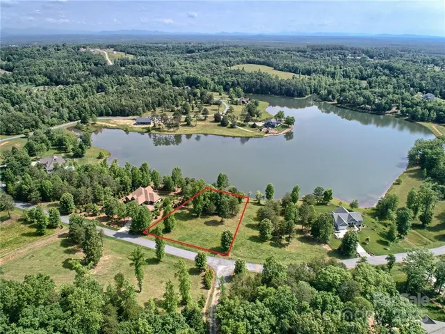 an aerial view of a house with a lake view