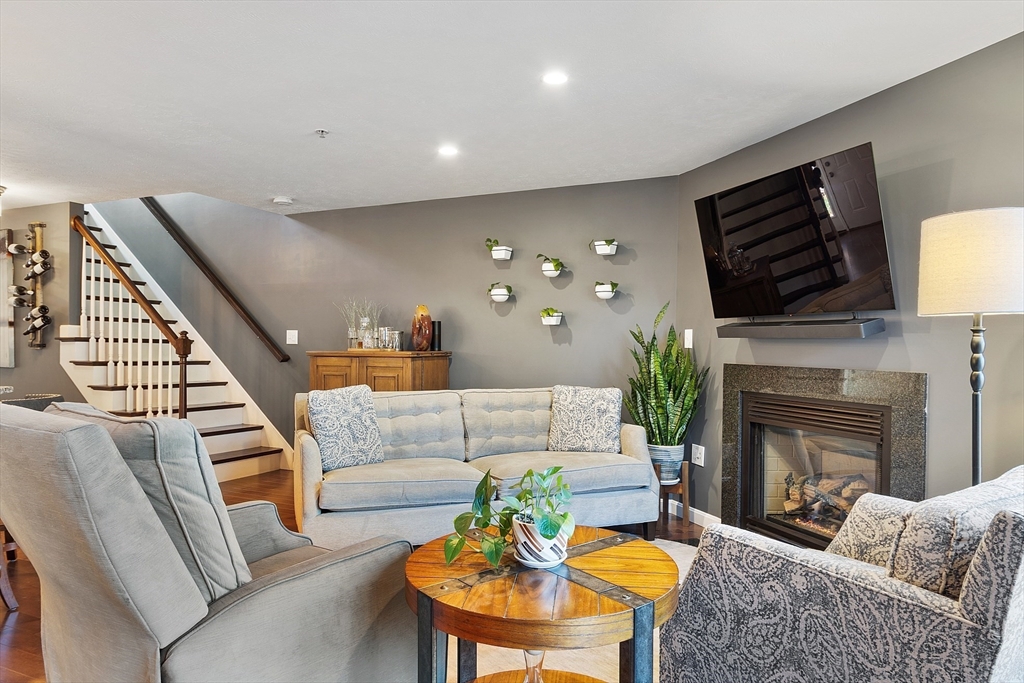 7 Green Briar Road, Unit 7 Fitchburg, MA 01420 - Photo 13 of 34 a living room with furniture a fireplace and a flat screen tv
