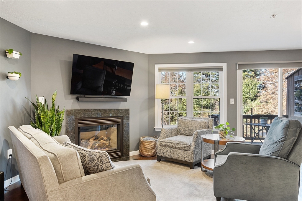 7 Green Briar Road, Unit 7 Fitchburg, MA 01420 - Photo 14 of 34 a living room with furniture a fireplace and a flat screen tv
