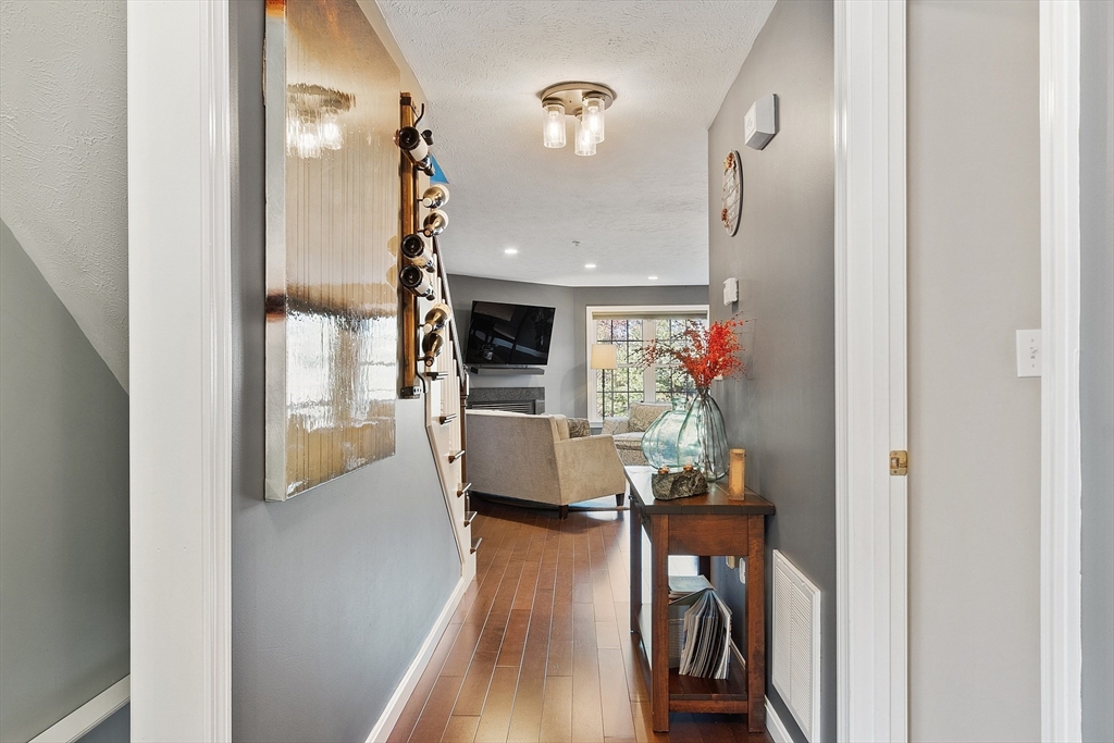 7 Green Briar Road, Unit 7 Fitchburg, MA 01420 - Photo 17 of 34 a living room with furniture a fireplace and wooden floor