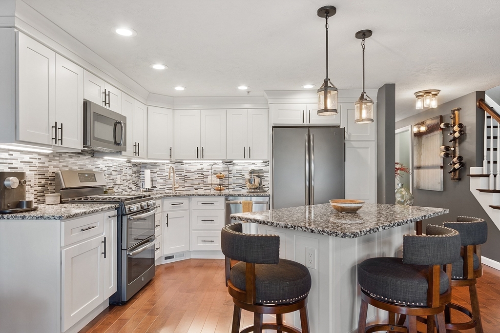 7 Green Briar Road, Unit 7 Fitchburg, MA 01420 - Photo 2 of 34 a kitchen with refrigerator cabinets dining table and chairs