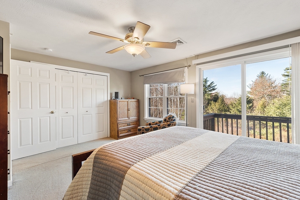 7 Green Briar Road, Unit 7 Fitchburg, MA 01420 - Photo 23 of 34 a bedroom with a large bed and a chandelier