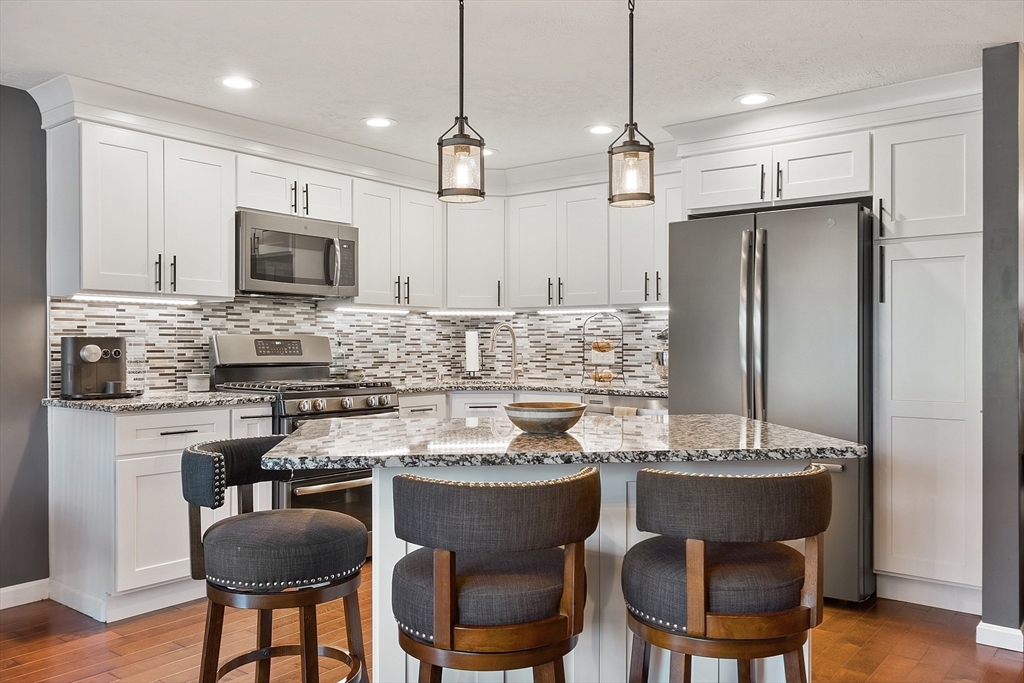 7 Green Briar Road, Unit 7 Fitchburg, MA 01420 - Photo 3 of 34 a kitchen with a dining table chairs sink and microwave