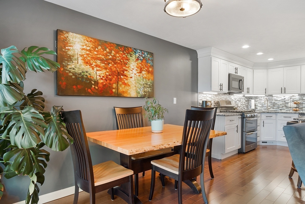 7 Green Briar Road, Unit 7 Fitchburg, MA 01420 - Photo 7 of 34 a dining room with furniture a potted plant and a kitchen view